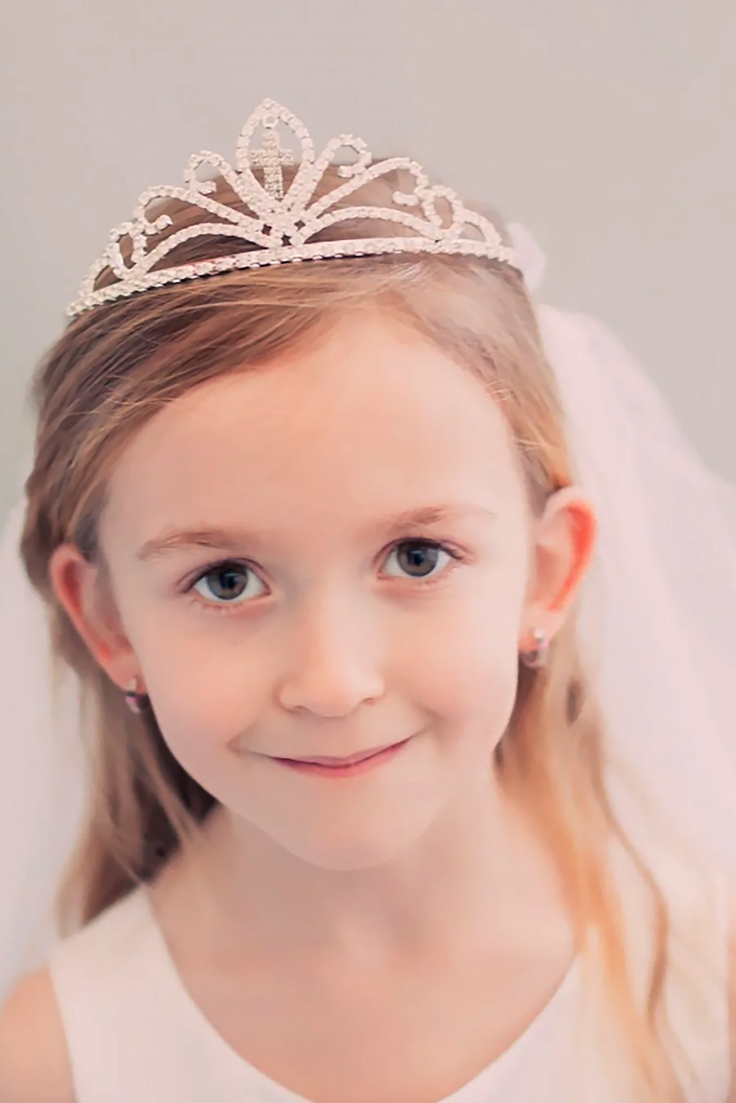 Silver and white rhinestone cross first communion tiara and two-tier veil, front view.