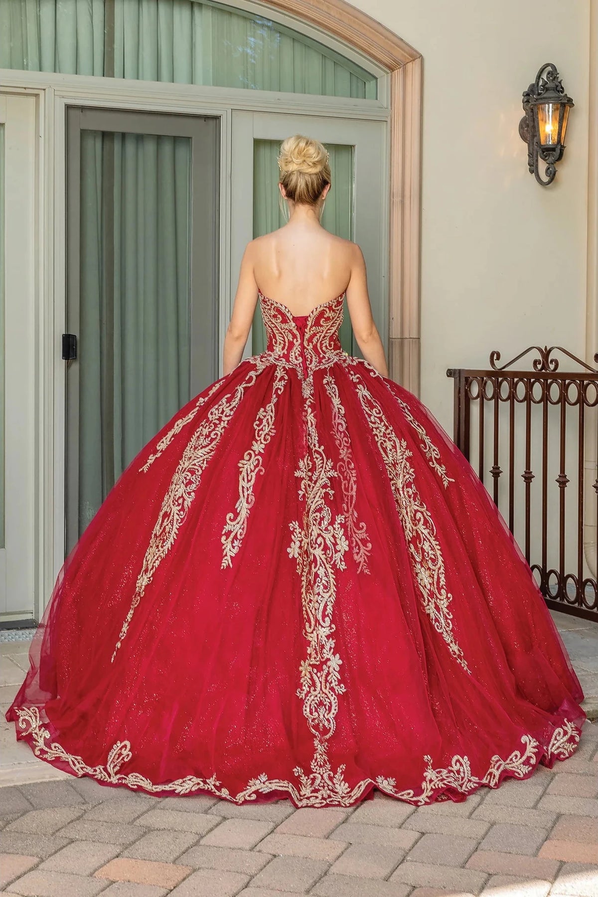Back view of a Burgundy quinceañera gown showing lace-up back and full tulle skirt