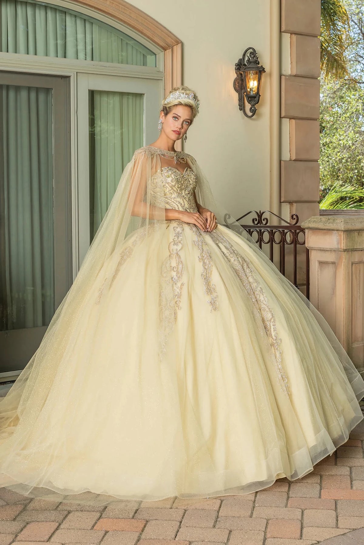 Front view of a Champagne quinceañera gown with strapless neckline, beaded bodice, and full tulle skirt