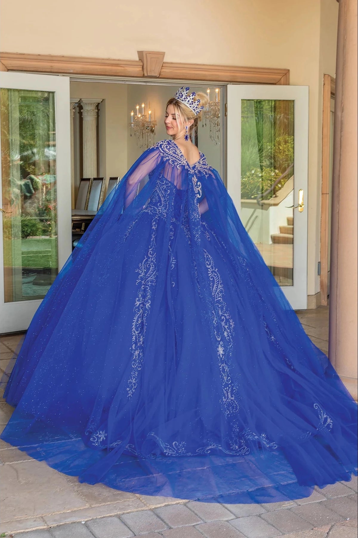 Back view of a Royal Blue quinceañera gown showing lace-up back and full tulle skirt