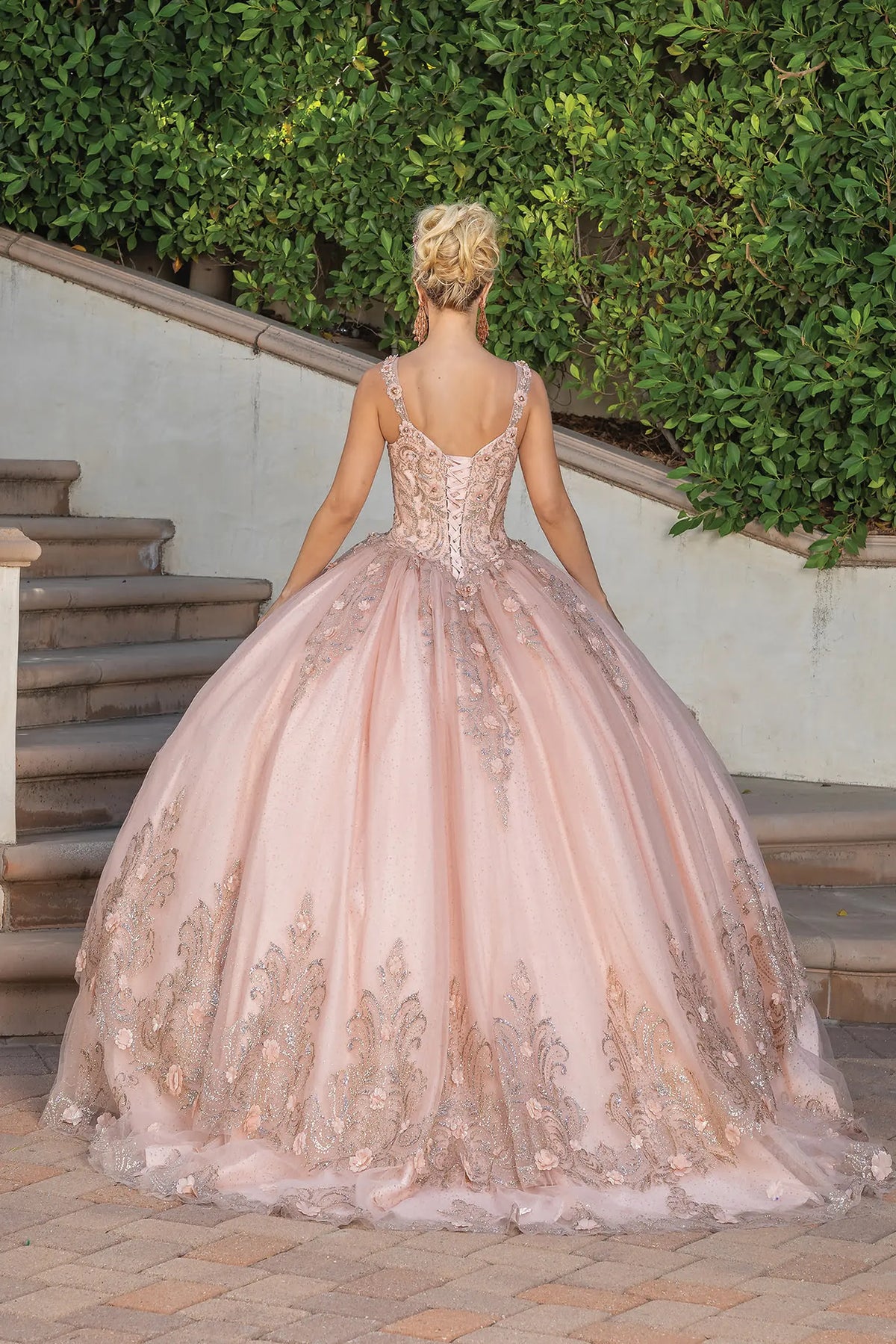 Highlighting scalloped embroidery, this Rose Gold quinceañera ball gown reveals detailing along the tulle hem.