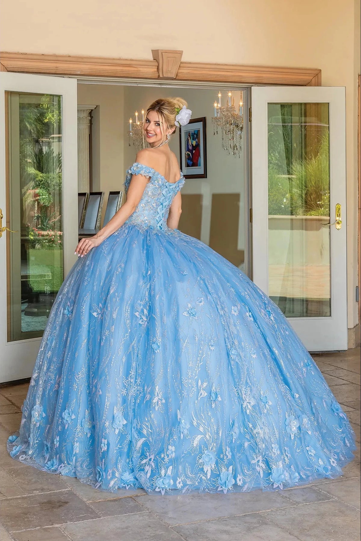 Back view of a Bahama Blue quinceañera gown showing lace-up back and glitter tulle skirt