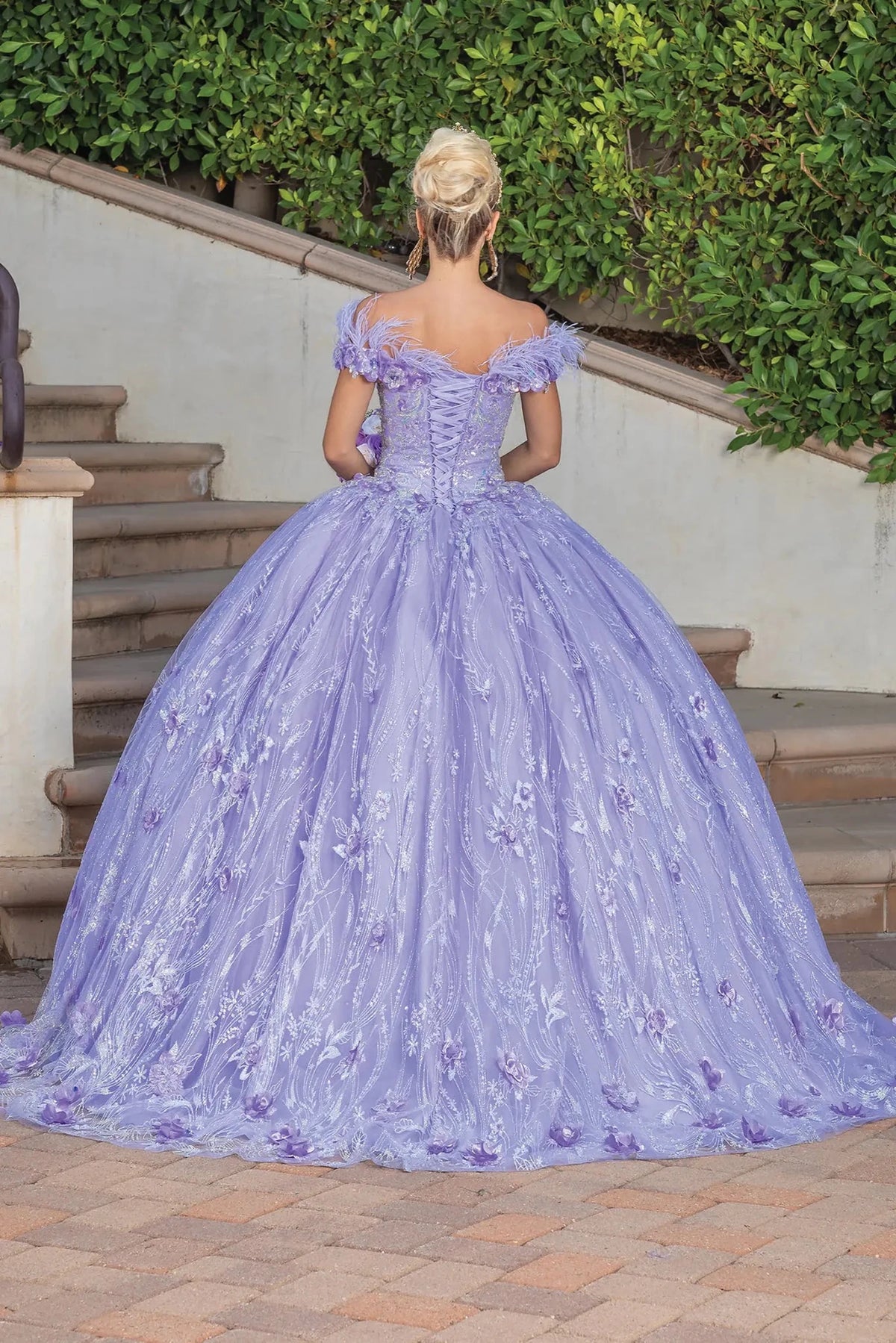 Back view of a Lilac quinceañera gown showing lace-up back and glitter tulle skirt