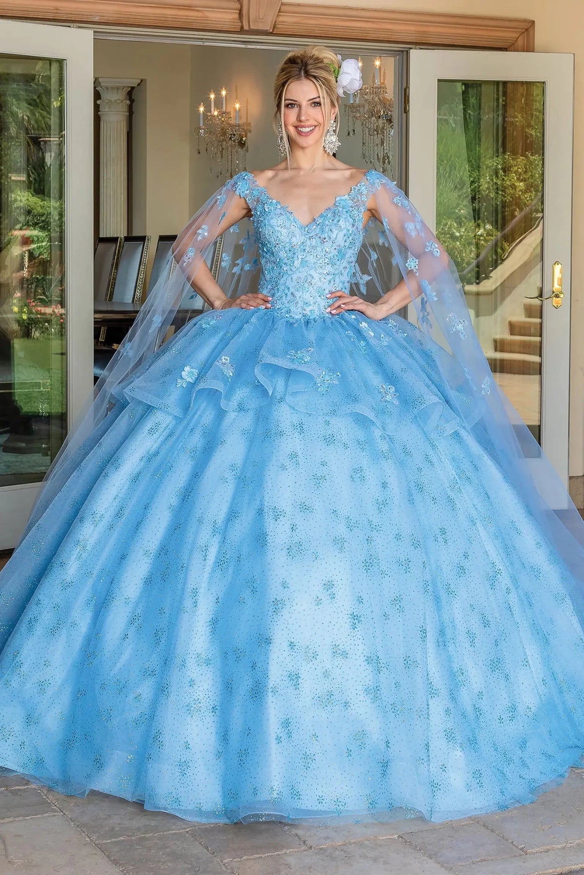 Front view of a Bahama Blue quinceañera gown with floral appliqués