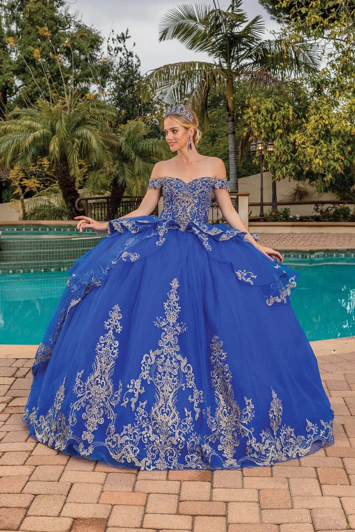 Front view of a Royal Blue quinceañera gown with off-the-shoulder neckline, ornate bodice, and voluminous full skirt