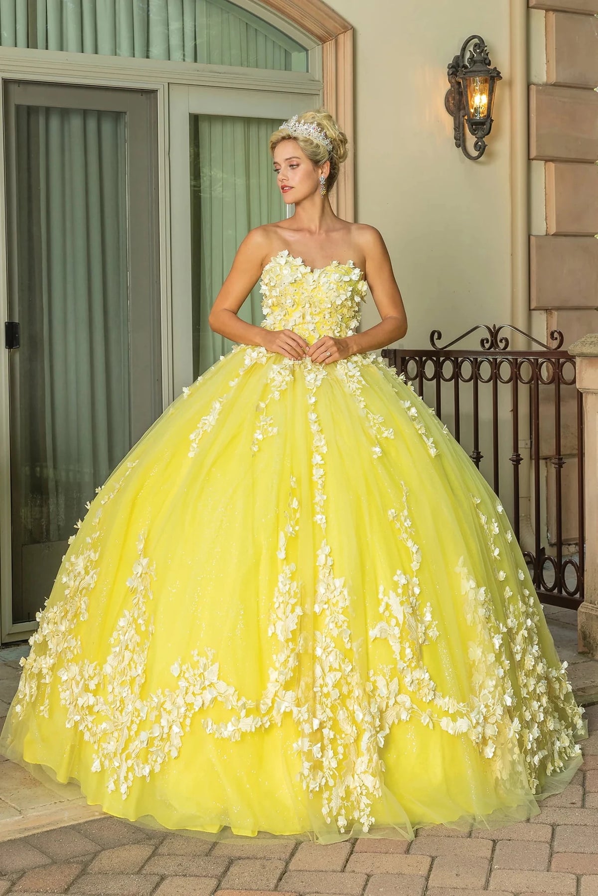 Additional full-length view of a Yellow quinceañera gown highlighting layered tulle skirt, floral appliqués, and strapless neckline