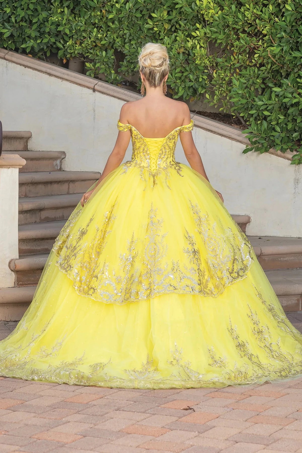 Back view of a Yellow quinceañera gown showing lace-up back and voluminous full skirt