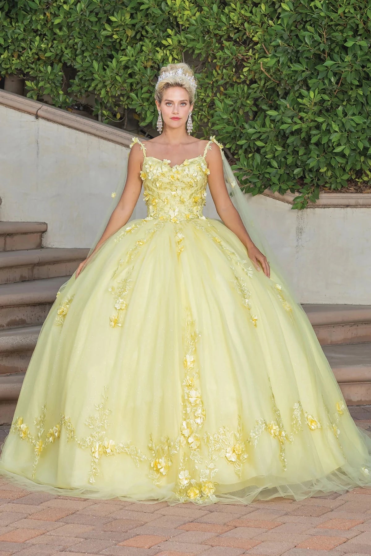Front view of a Yellow quinceañera gown with cap sleeves and floral appliqués