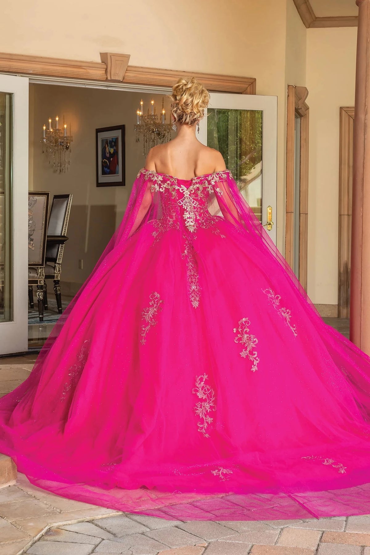 Back view of a Fuchsia quinceañera gown showing lace-up back and floral embroidery
