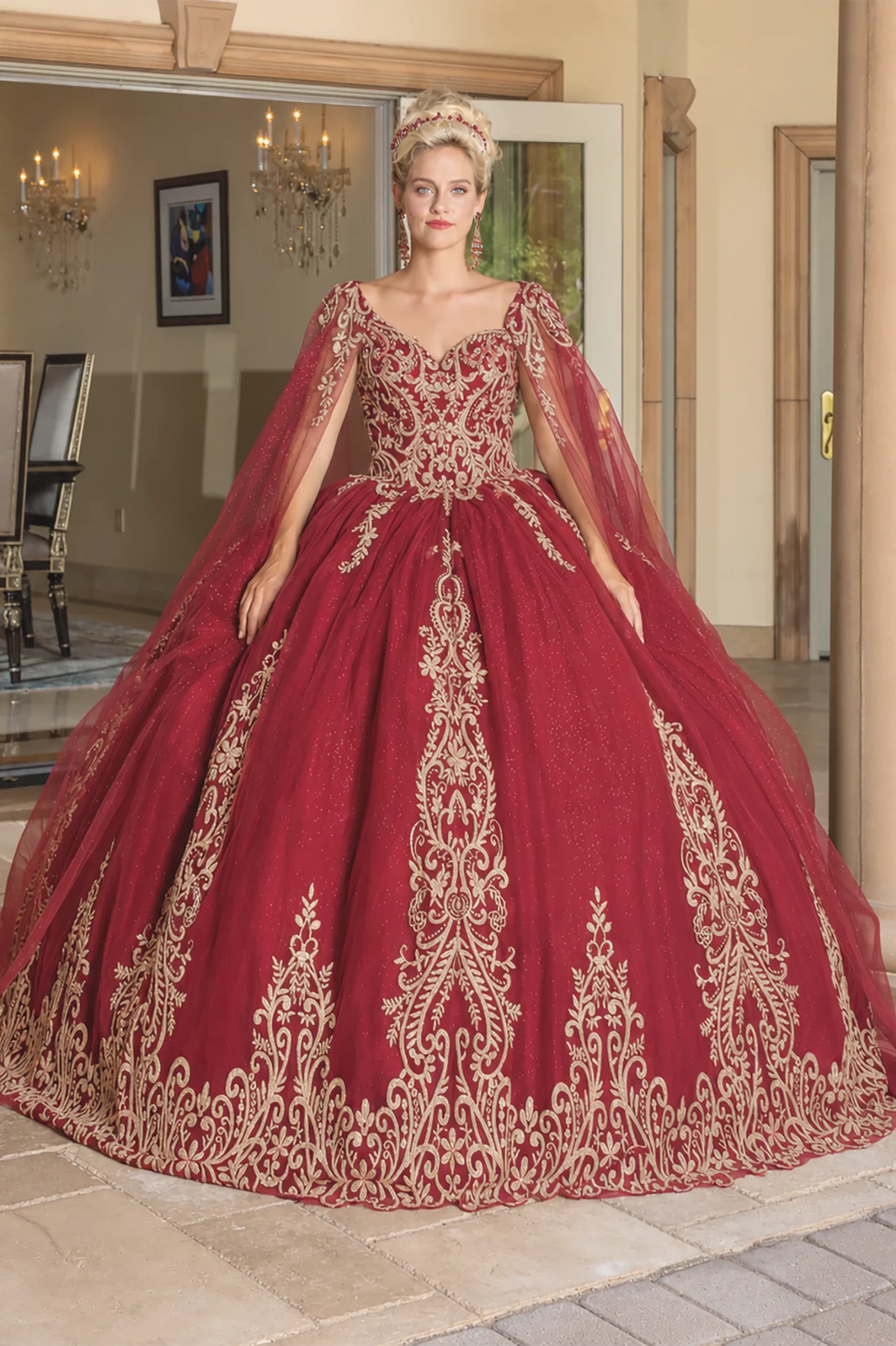 burgundy quince ball gown with extensive gold embroidery and sheer draped sleeves