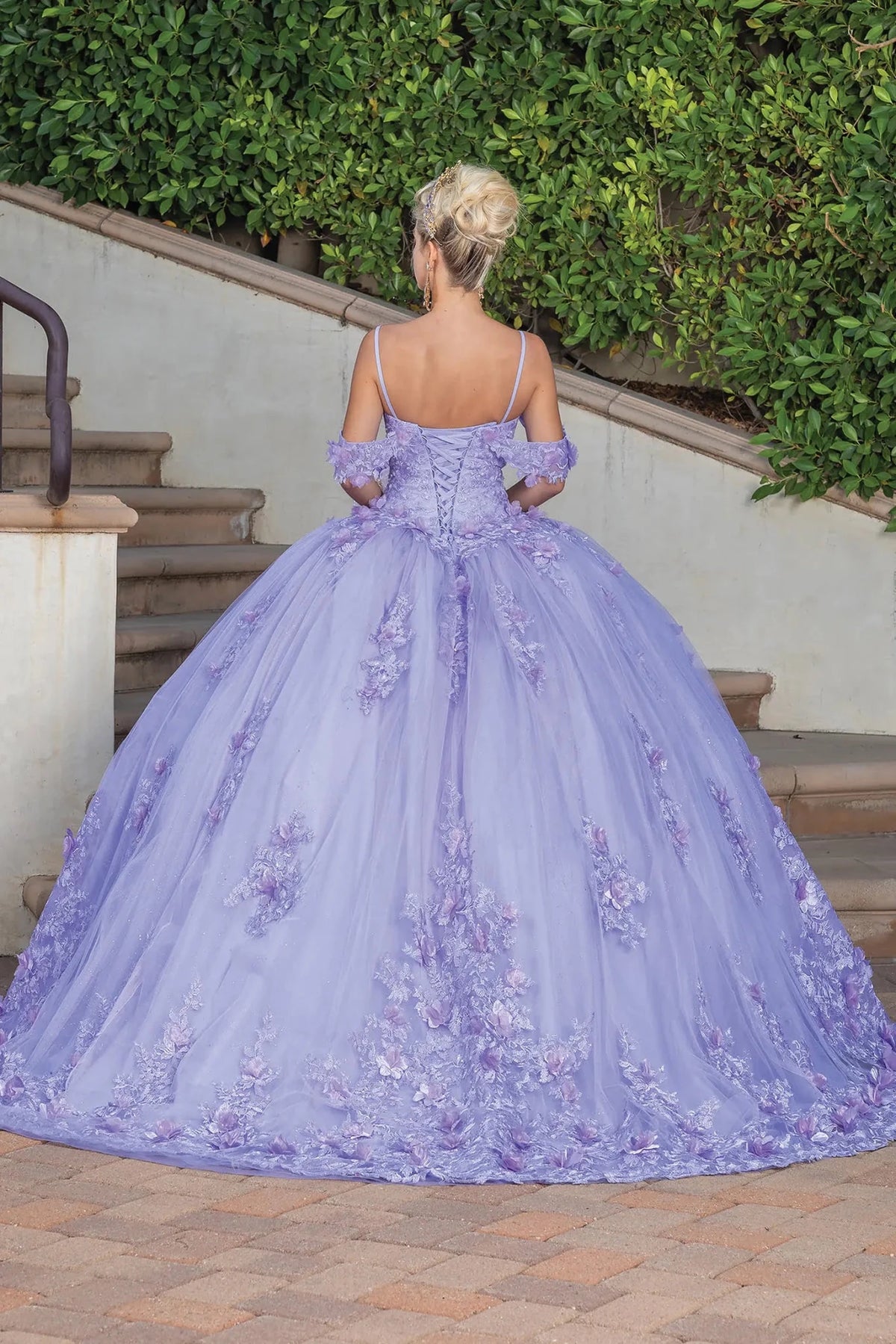 Full-length back view of a Lilac quinceañera gown showing lace-up back and floral appliqués