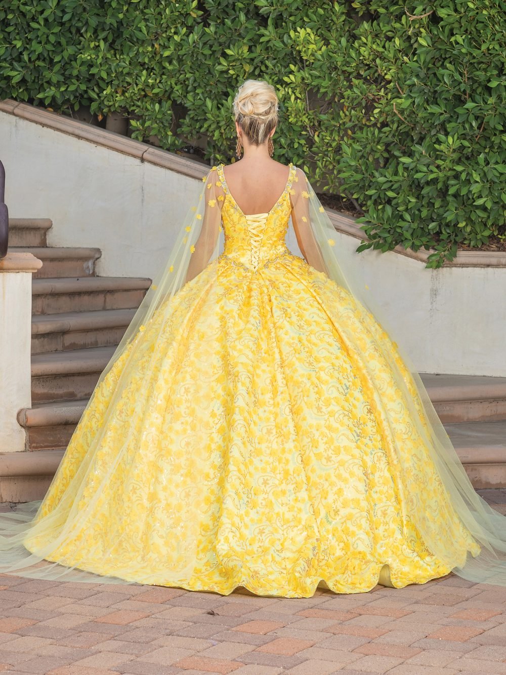 Yellow Embellished Bodice Ballgown with Sheer Overlay and Floral Appliqués Quince dress - back view of woman wearing dress