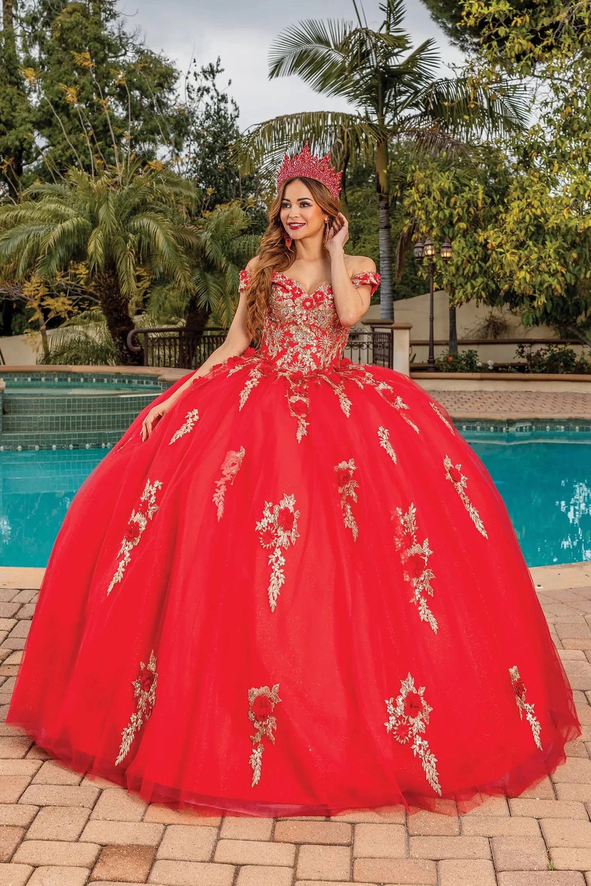 Front view of a Red quinceañera gown with off-the-shoulder neckline, floral appliqués, and glitter tulle skirt
