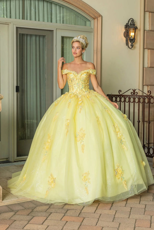 Showing floral appliqués scattered over its glitter tulle skirt, this Yellow quinceañera ball gown is shown in full view.