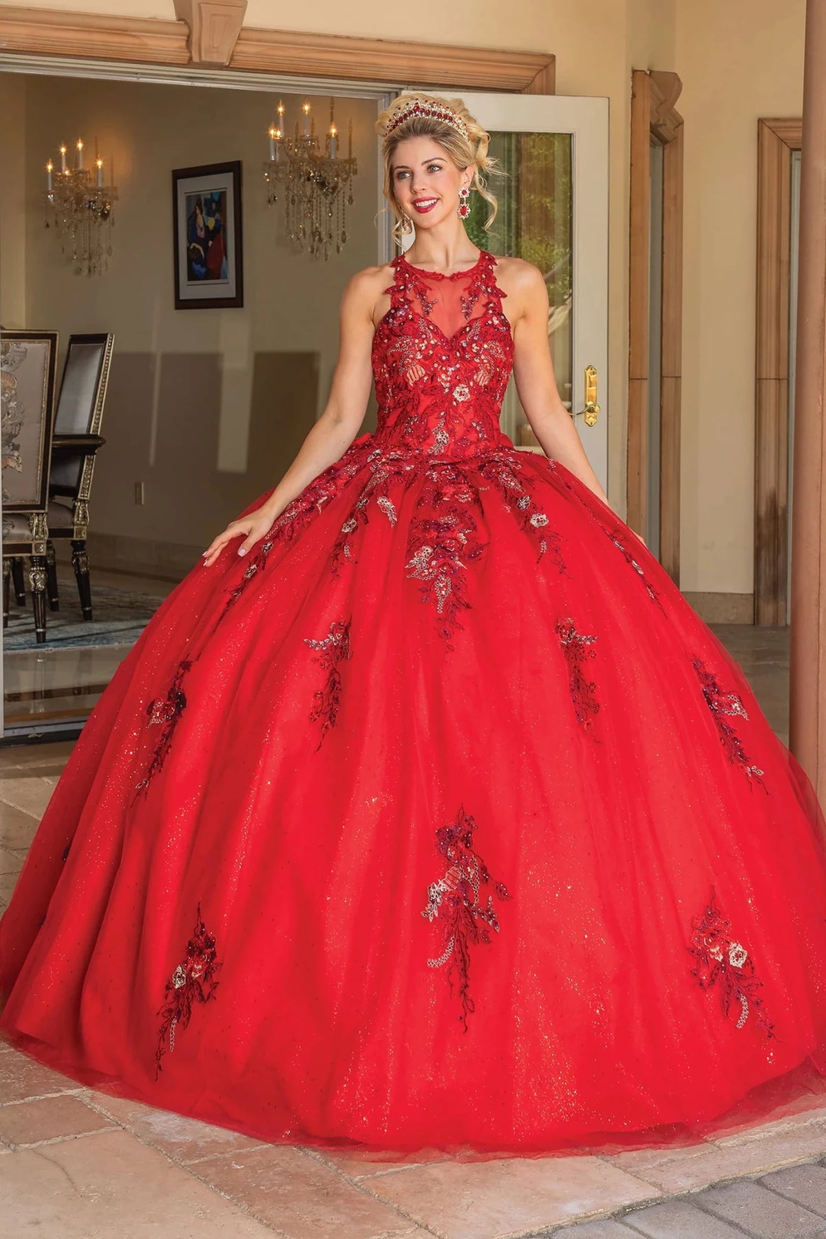 Front view of a Red quinceañera gown with floral embroidery and ruffled layered skirt
