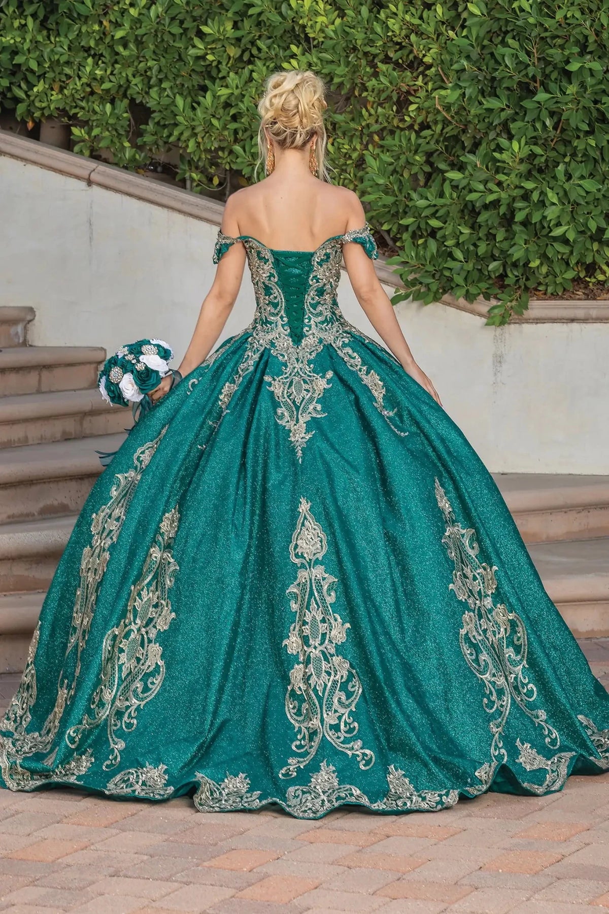 Back view of a Hunter Green quinceañera gown showing lace-up back and voluminous full skirt