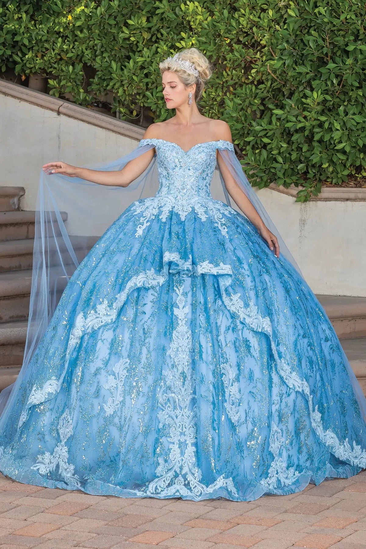 Front view of a Bahama Blue quinceañera gown with off-the-shoulder neckline and sheer sleeves