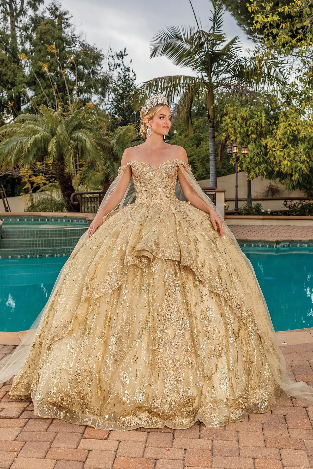 Front view of a Gold quinceañera gown with embroidered lace