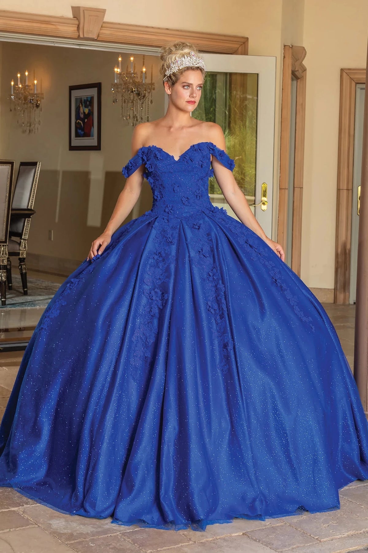 Front view of a Royal Blue quinceañera gown with off-the-shoulder neckline, floral appliqués, and glitter tulle skirt