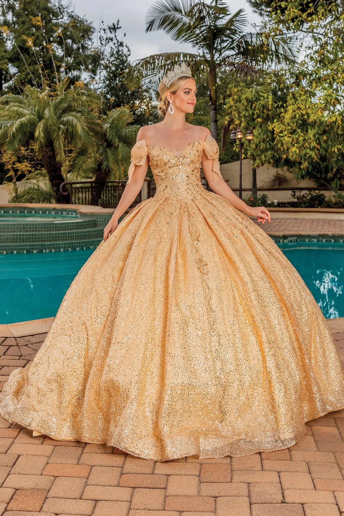 Front view of a Gold quinceañera gown with cap sleeves and embroidered bodice