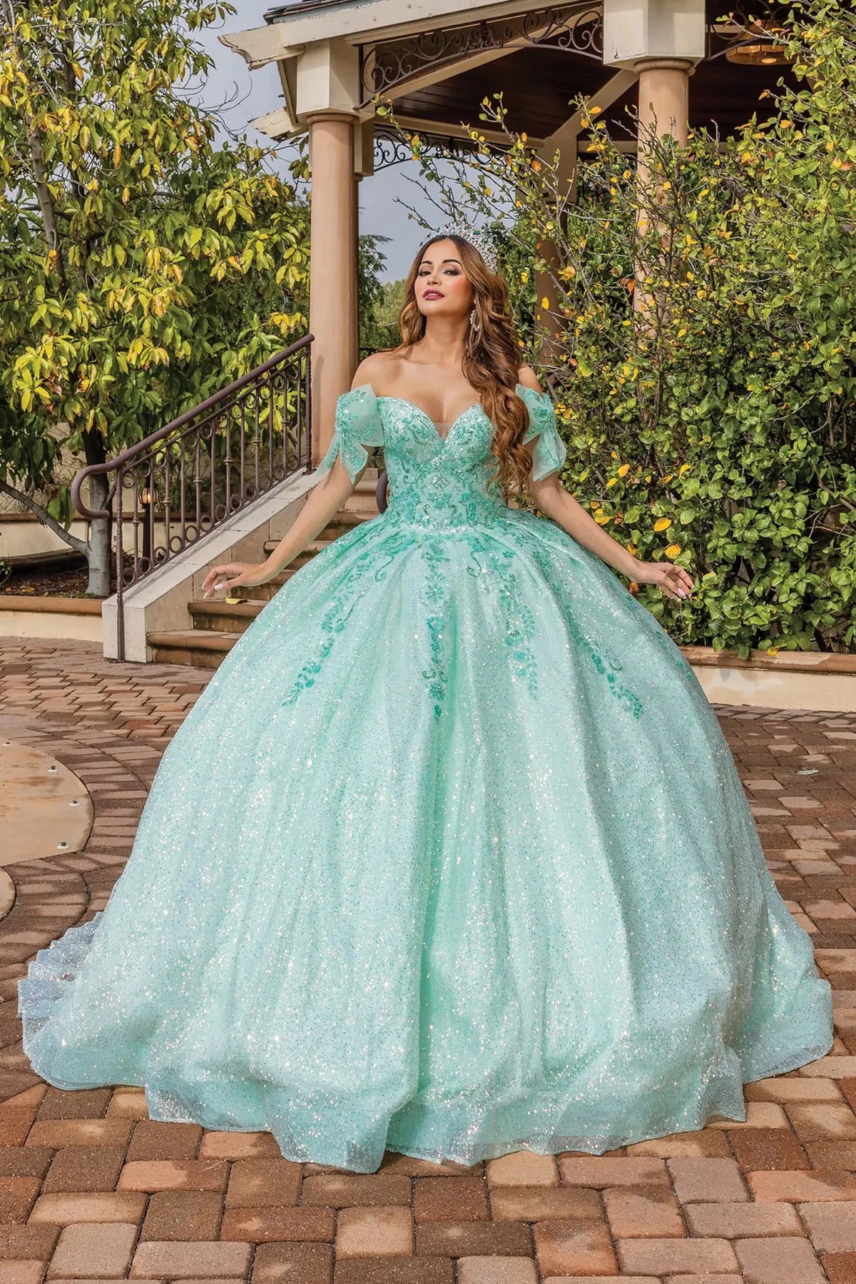 Front view of a Mint quinceañera gown with cap sleeves and embroidered bodice