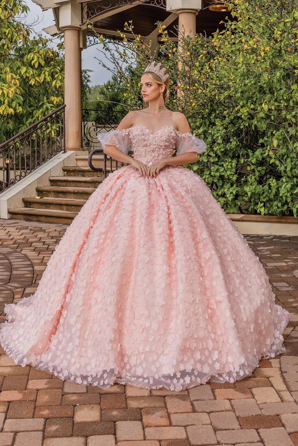 Front view of a Blush quinceañera gown with off-the-shoulder neckline and floral appliqués