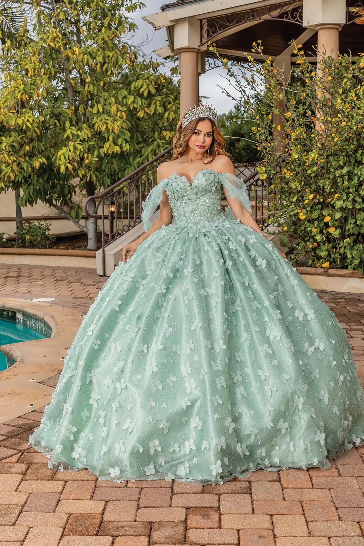 Front view of a Sage quinceañera gown with off-the-shoulder neckline and floral appliqués