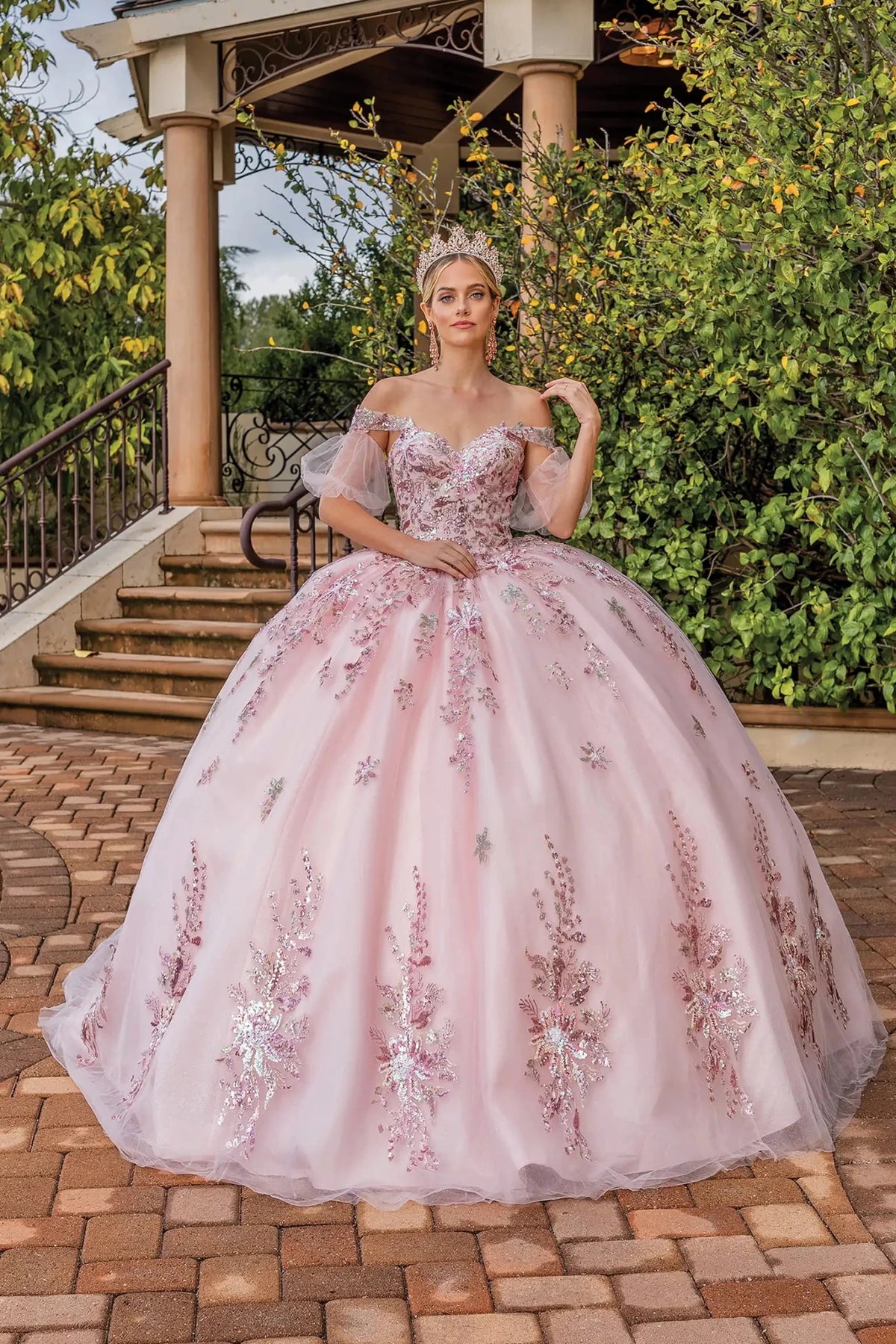 Front view of a Blush quinceañera gown with sweetheart neckline, sheer long sleeves, and beaded bodice