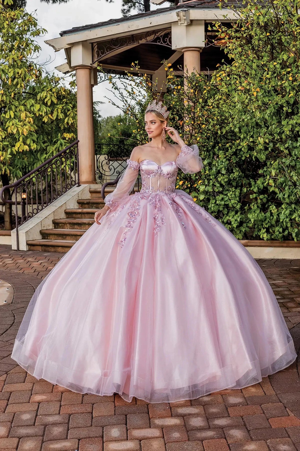 Front view of a Blush quinceañera gown with corset bodice and floral appliqués