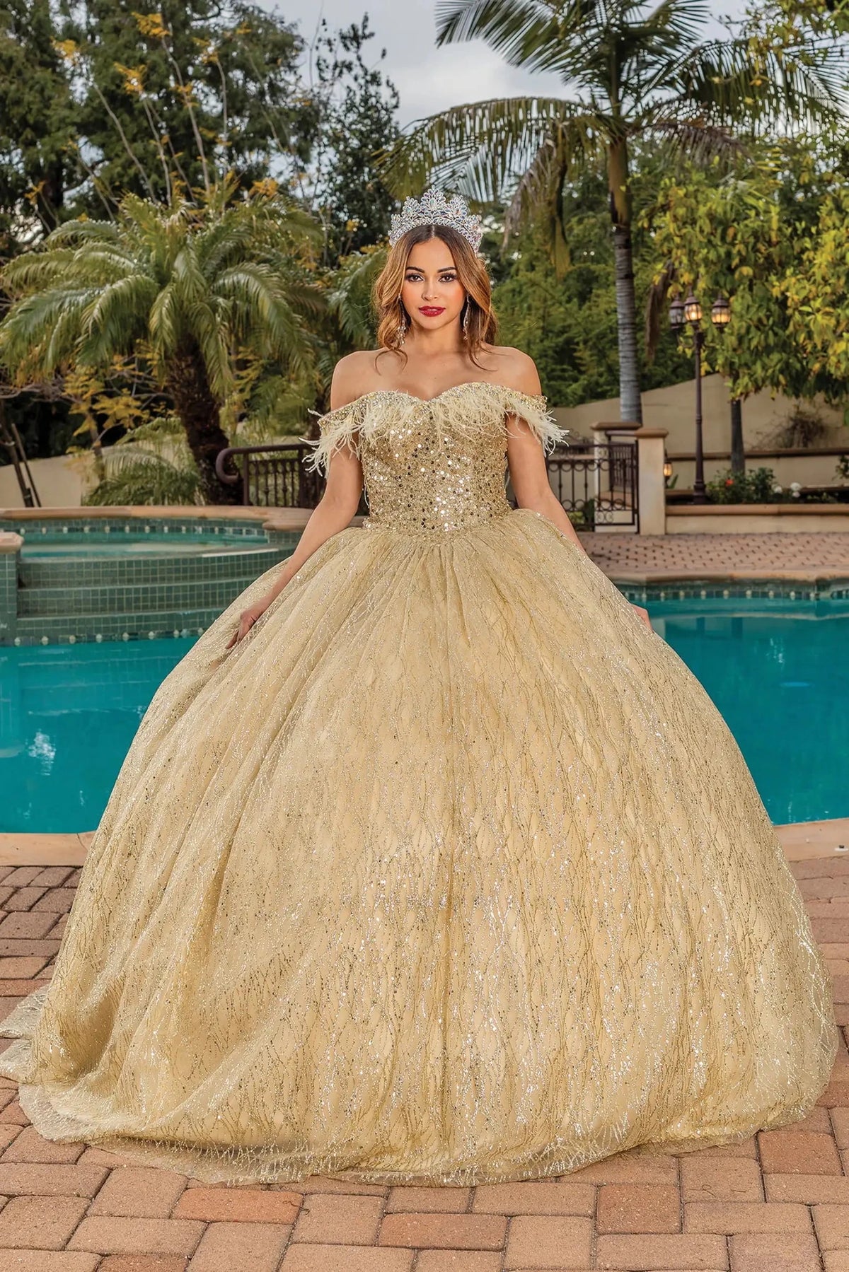 Front view of a Gold quinceañera gown with off-the-shoulder neckline, beaded lace bodice, and glitter tulle skirt