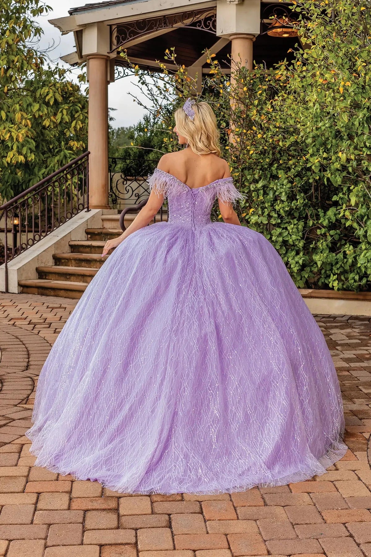 Rear view of a Lilac quinceañera gown showing lace-up back and glitter tulle skirt