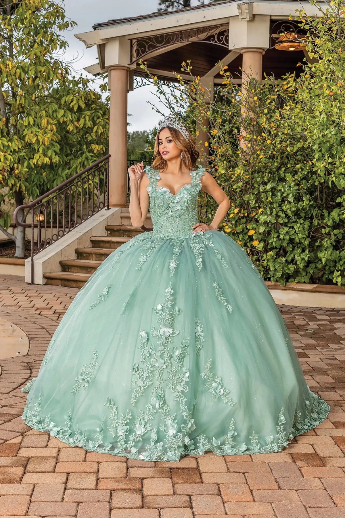 Front view of a Sage quinceañera gown with embroidered corset bodice and floral appliqués