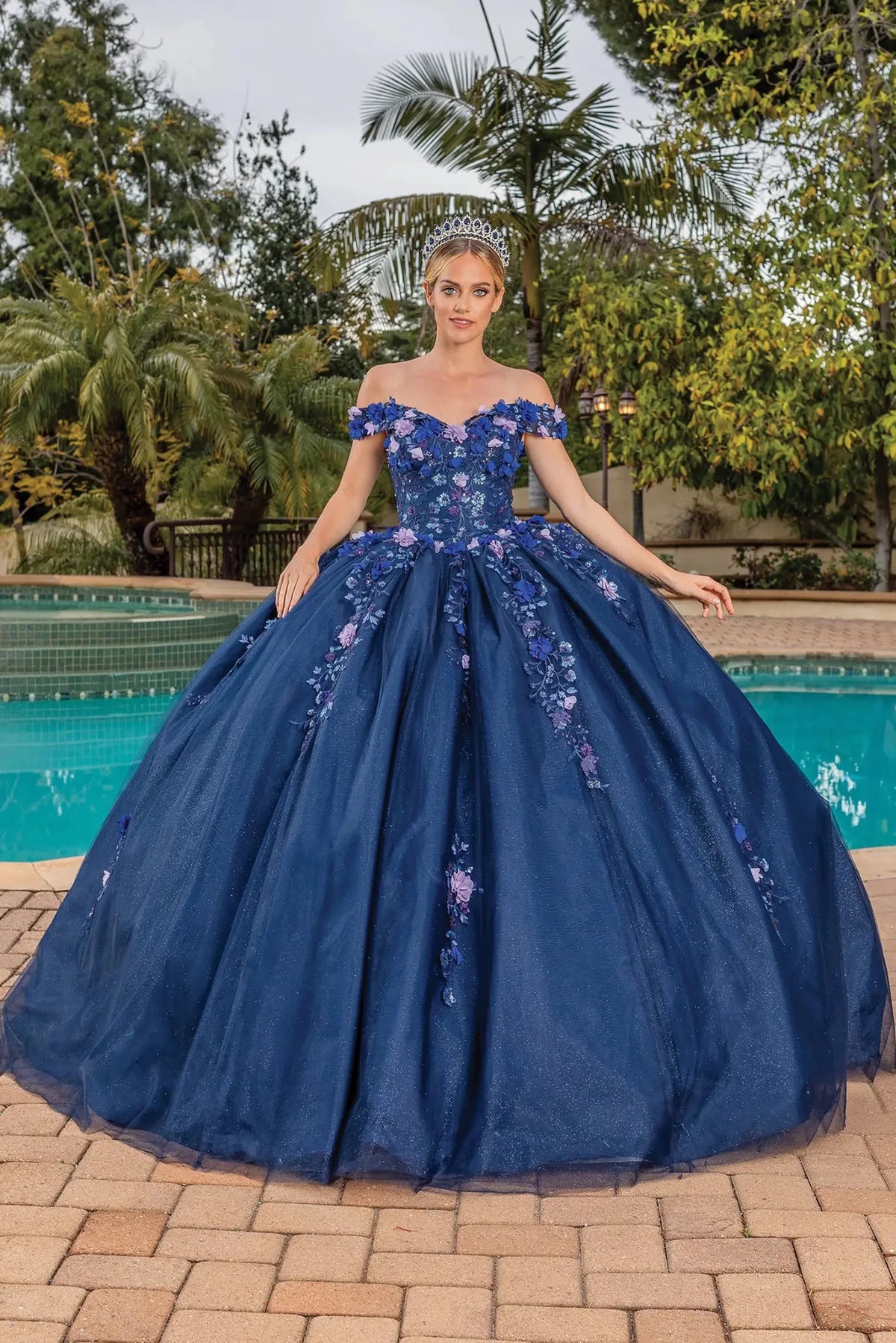Front view of a Navy quinceañera gown with off-the-shoulder neckline and embroidered tulle skirt