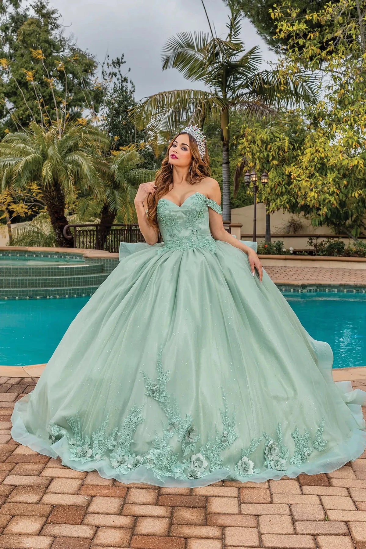 Front view of a Sage quinceañera gown with sweetheart neckline, beaded bodice, and ruffled layered skirt