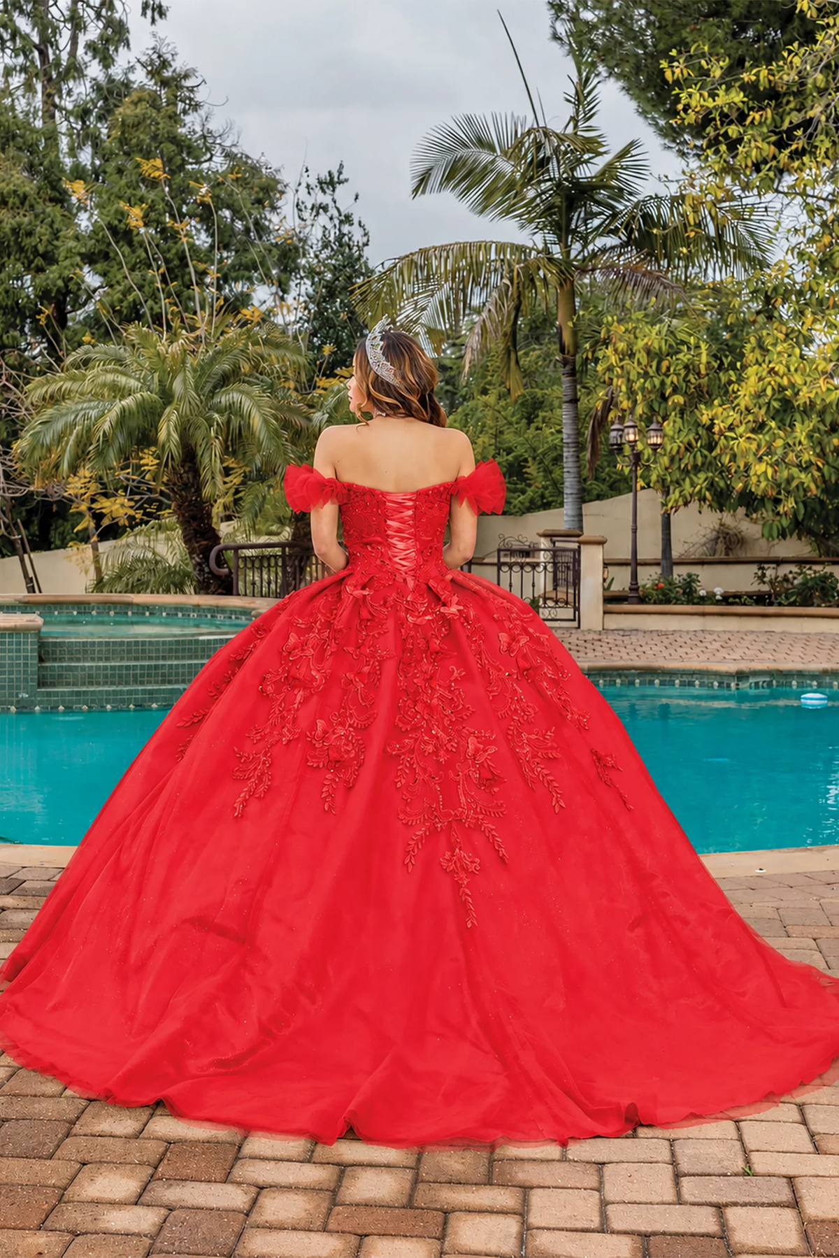 Red embroidered lace quinceanera dress, back view with lace-up closure