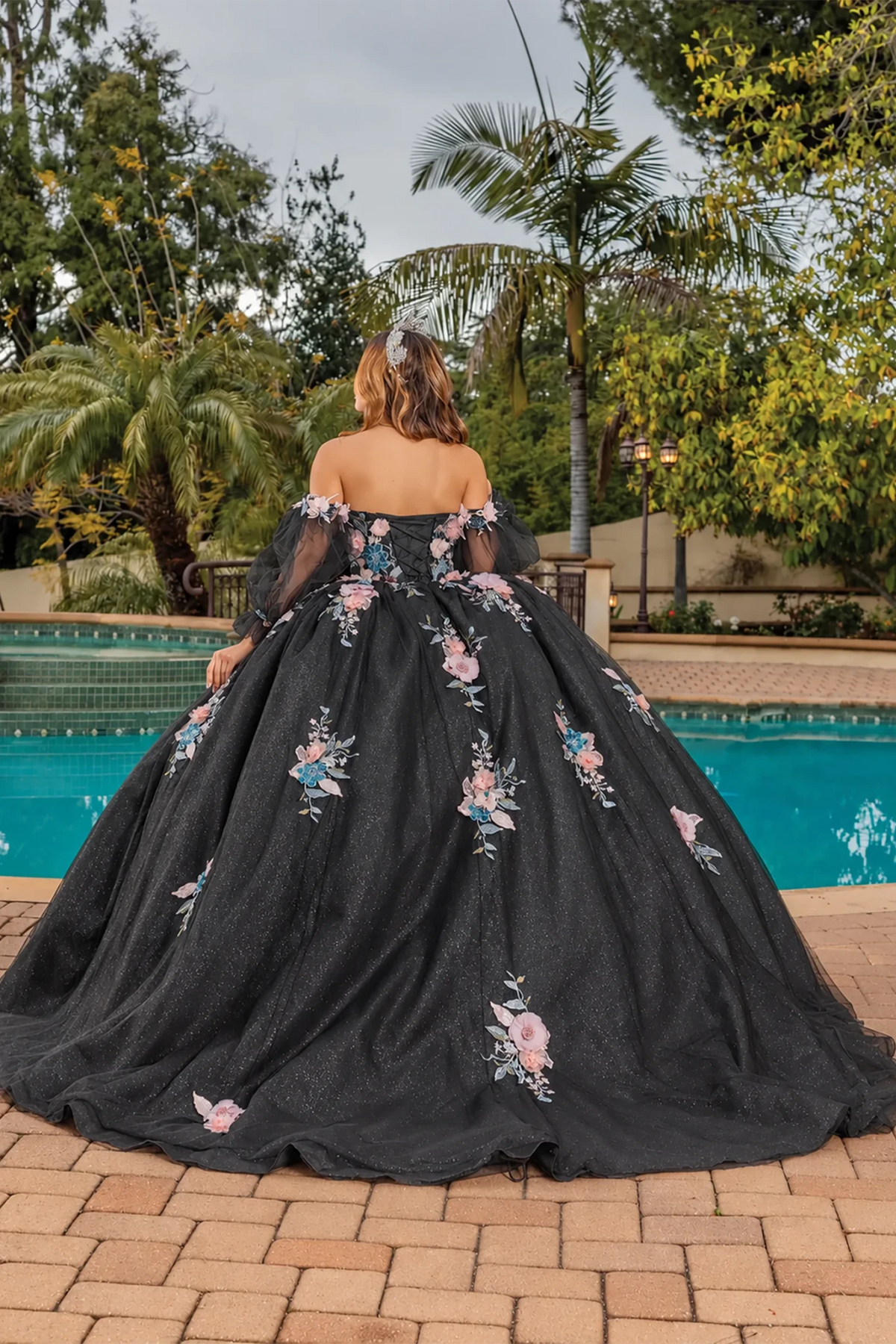 voluminous off-the-shoulder black ball gown with pink and blue floral embroidery