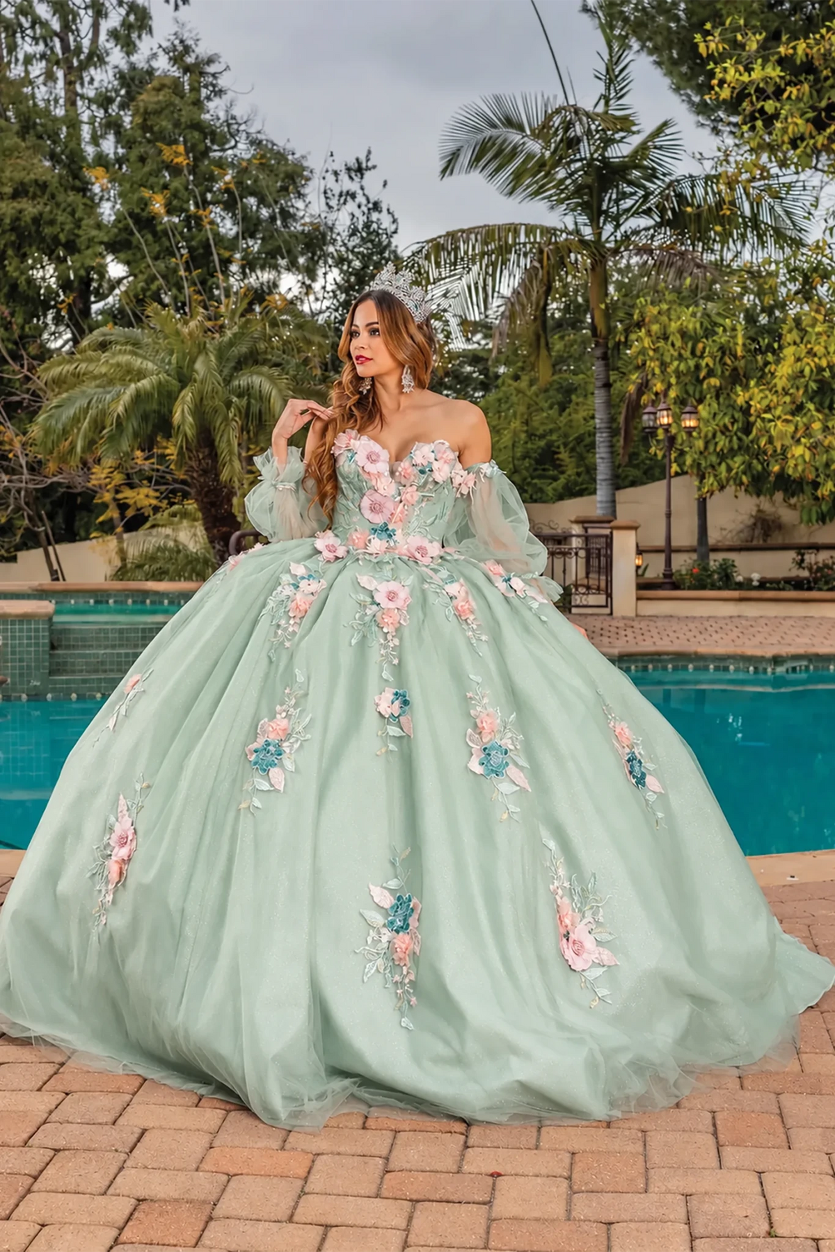 voluminous sage green ball gown with pink and blue floral embroidery with long sheer sleeves