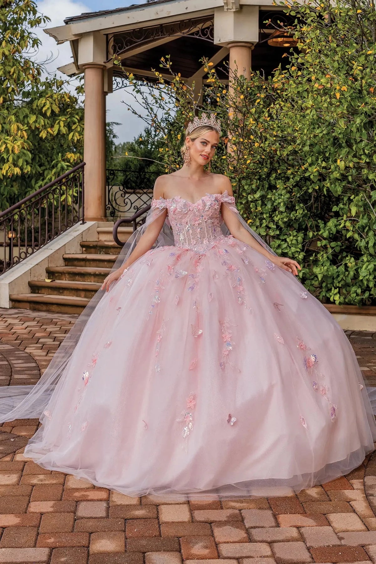 Front view of a Blush quinceañera gown with detachable sleeves, beaded bodice, and floral appliqués