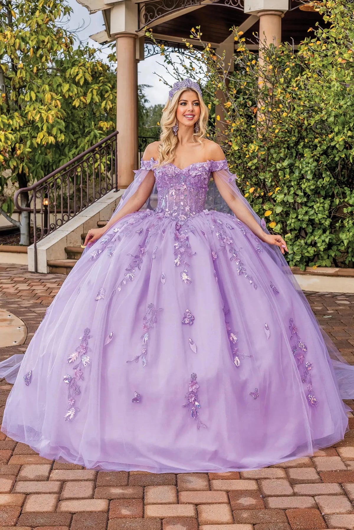 Front view of a Lilac quinceañera gown with detachable sleeves, beaded bodice, and floral appliqués
