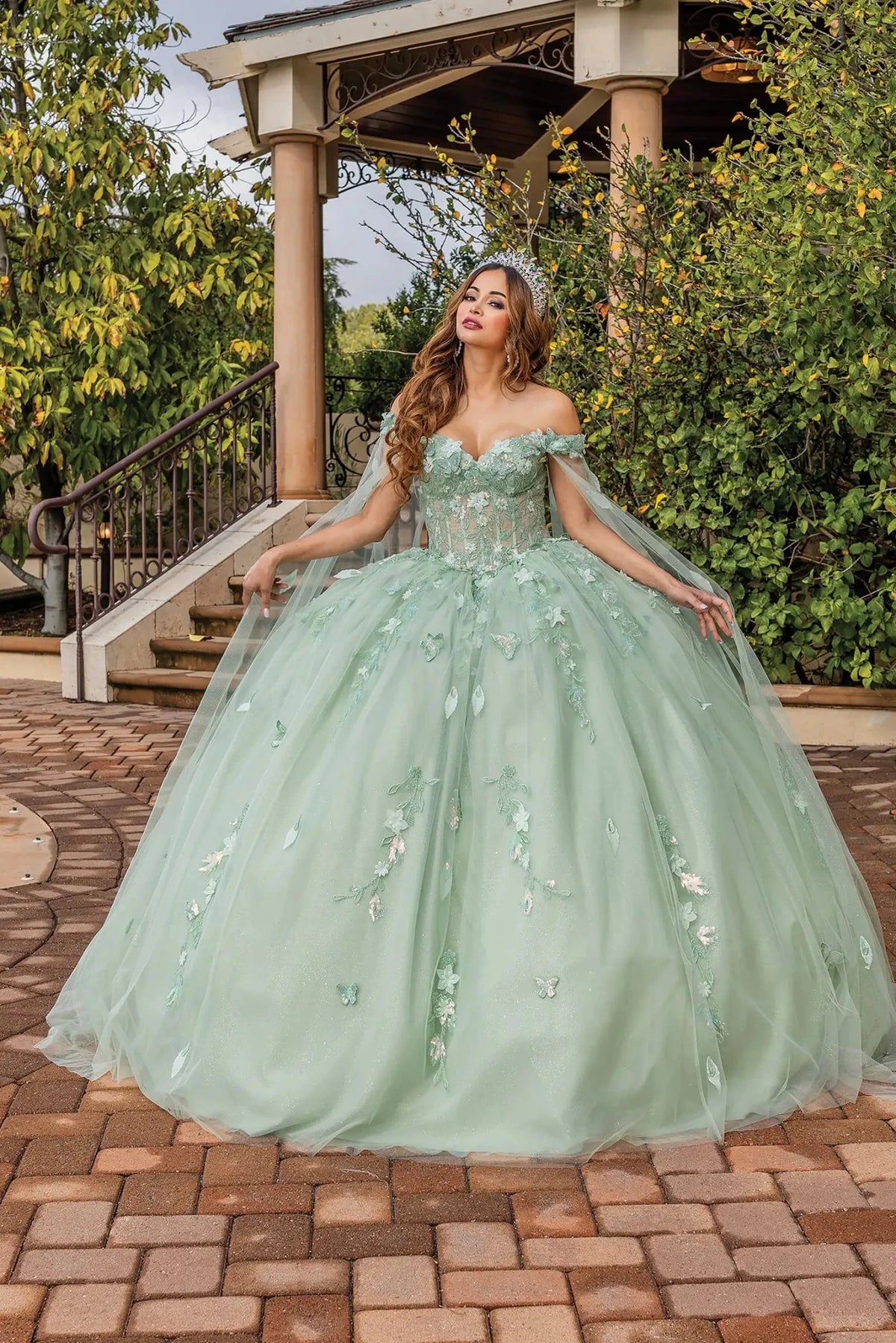 Front view of a Sage quinceañera gown with detachable sleeves, beaded bodice, and floral appliqués