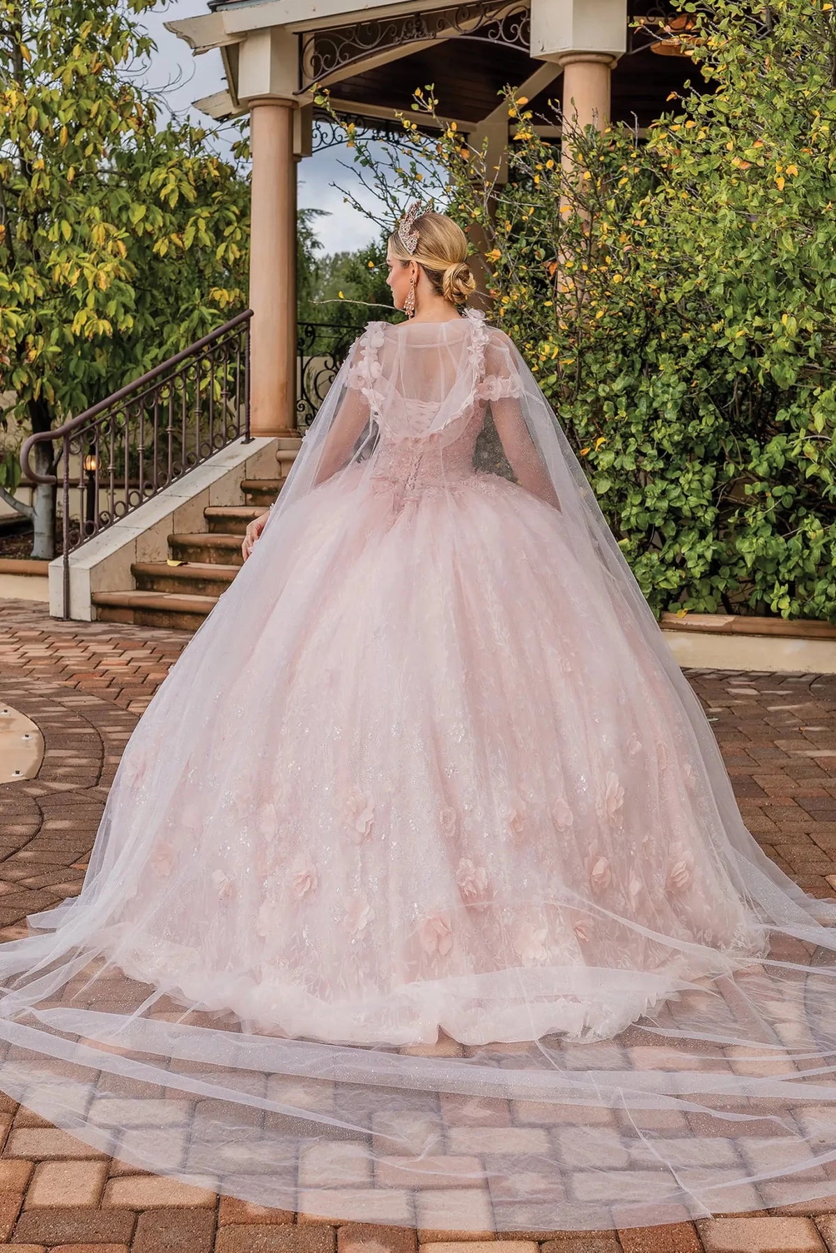 Additional full-length view of a Light Blush quinceañera gown highlighting layered tulle skirt, floral appliqués, and sheer sleeves