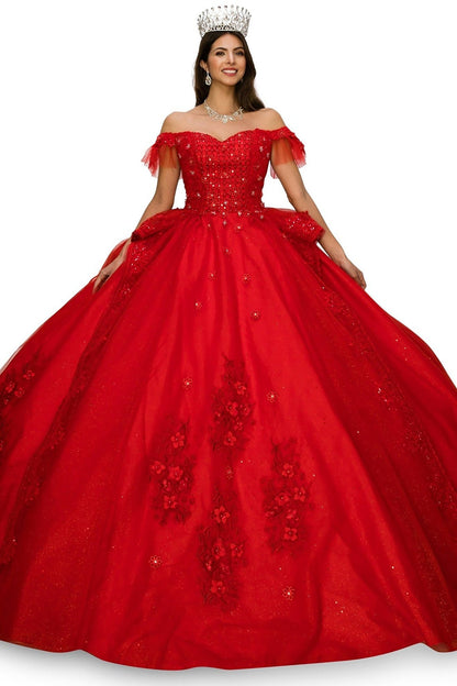 Woman wearing a red ball gown with floral embroidery and a crown on a white background
