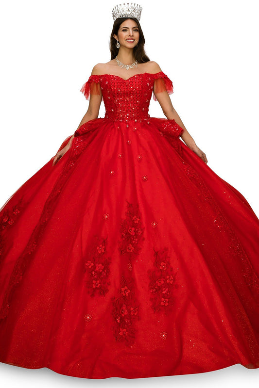 Woman wearing a red ball gown with floral embroidery and a crown on a white background