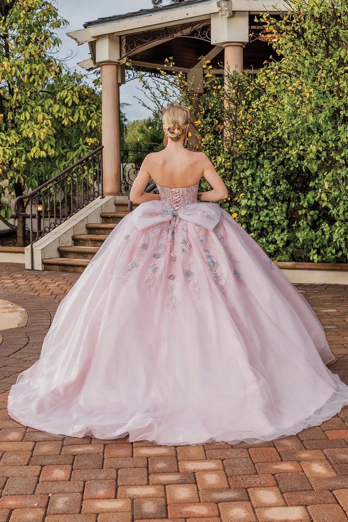 Rear view of a Blush quinceañera gown showing lace-up back and floral embroidery
