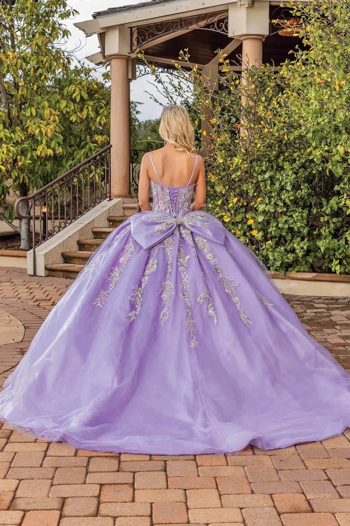 Back view of a Lilac quinceañera gown showing lace-up back and floral embroidery