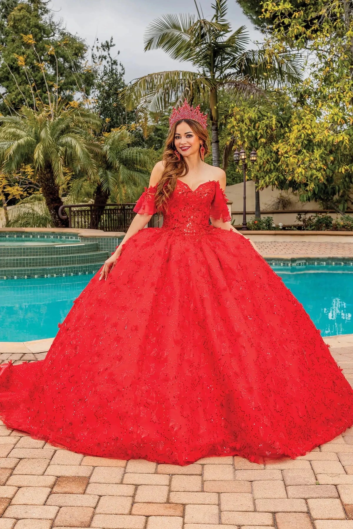 Front view of a Red quinceañera gown with off-the-shoulder neckline and full tulle skirt
