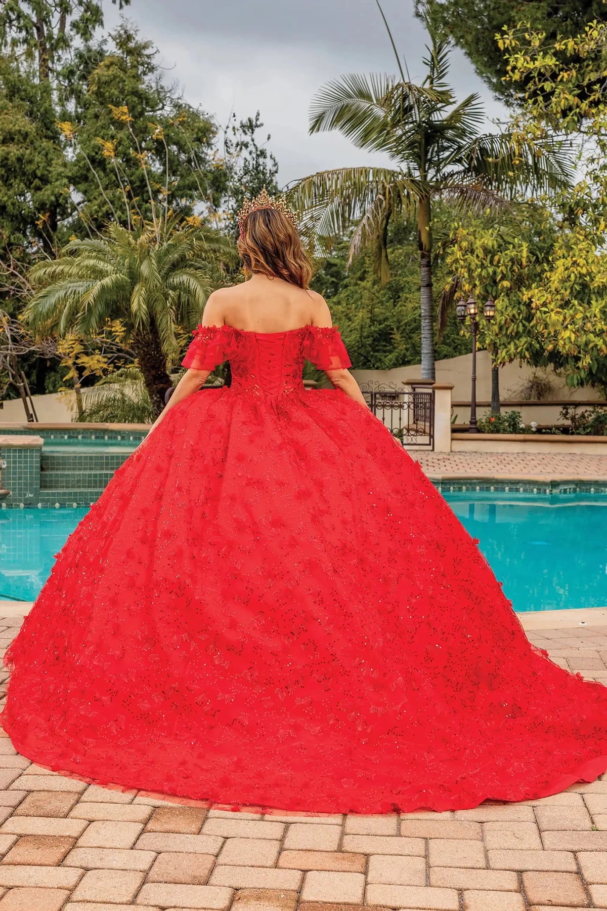 Back view of a Red quinceañera gown showing lace-up back and full tulle skirt