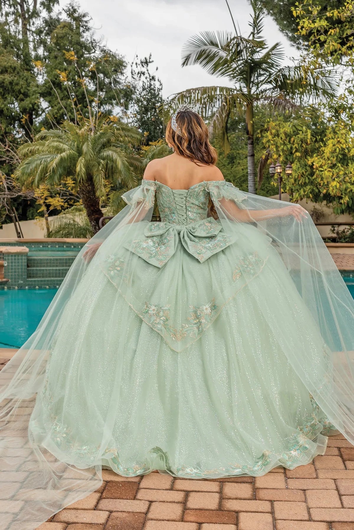 Back view of a Sage quinceañera gown showing lace-up back and embroidered tulle skirt