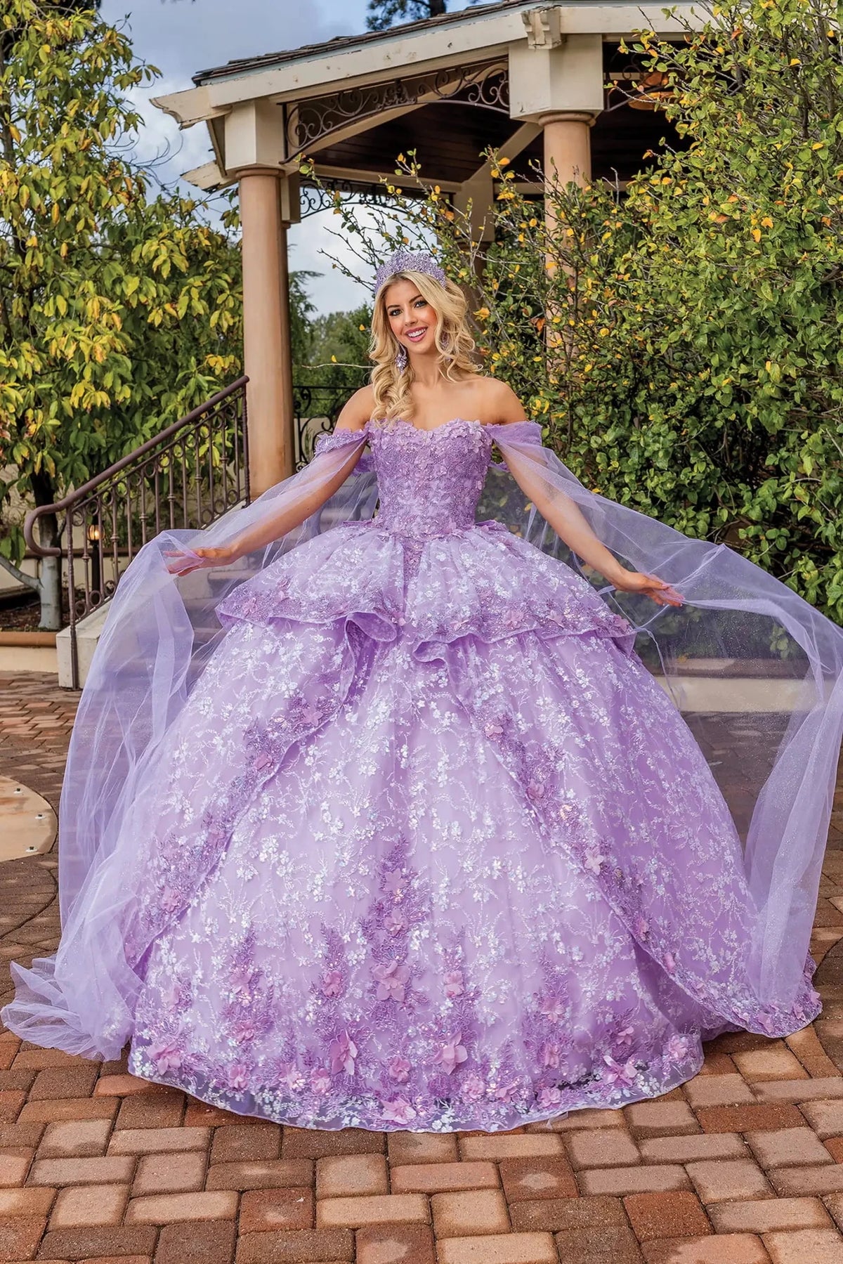 Front view of a Lilac quinceañera gown with detachable sleeves and floral appliqués