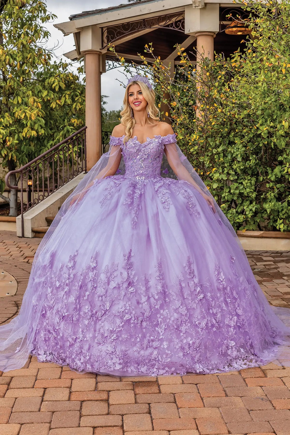 Front view of a Lilac quinceañera gown with off-the-shoulder neckline, floral embroidery, and full tulle skirt